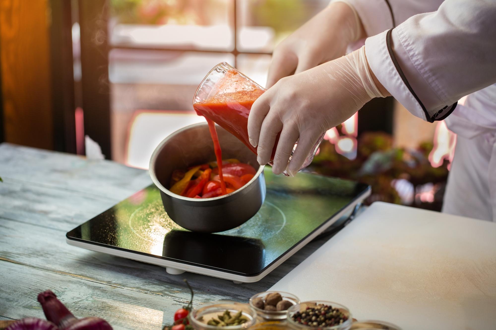 Chef demonstrating sauce technique to small group